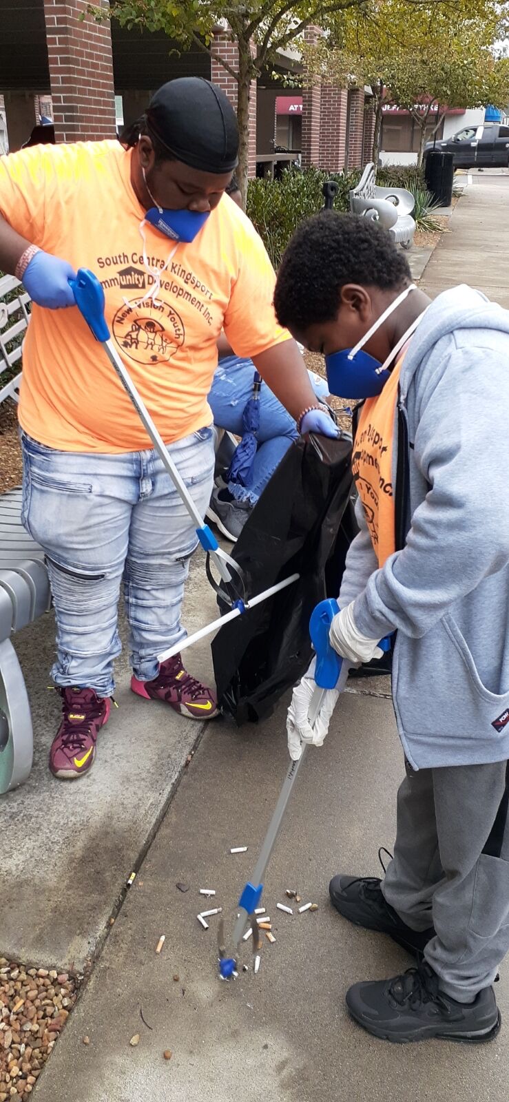 New Vision volunteers help with downtown cleanup